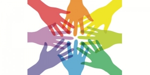 Eight hands in rainbow colors joining in the center